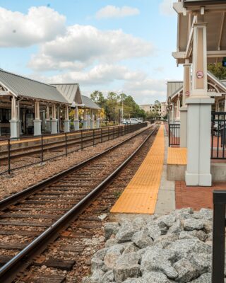 a train station with a train on the tracks